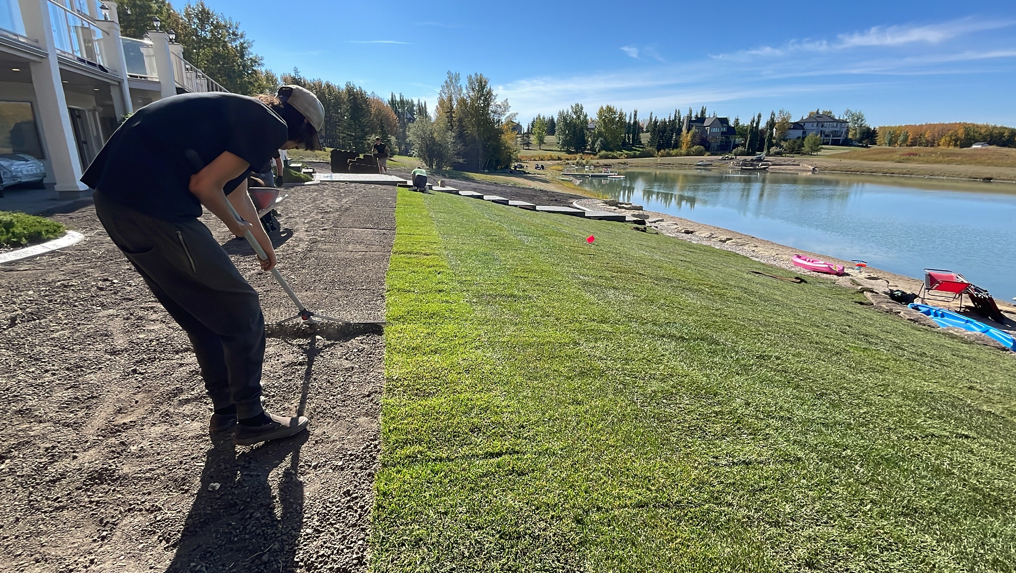 raking topsoil in preparation of sod installation